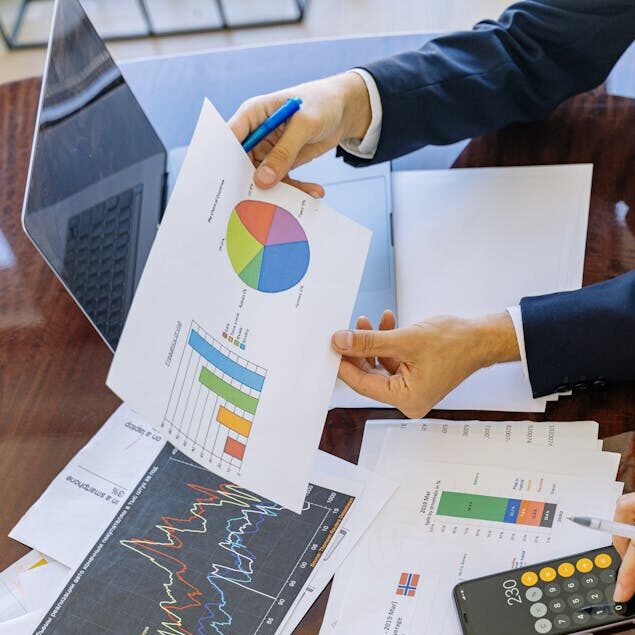 Business professionals analyzing financial charts and graphs during a meeting.